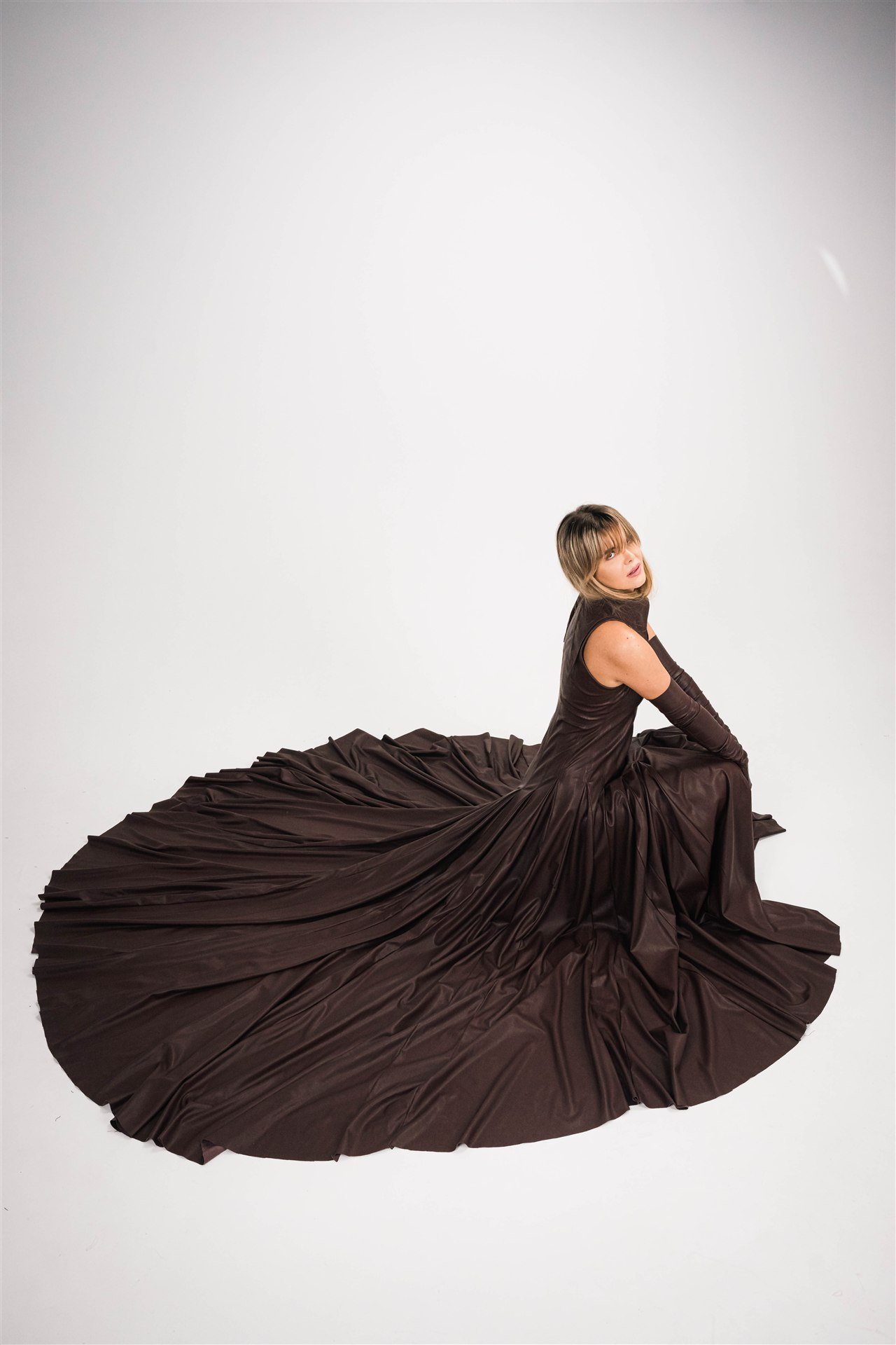 Fashion model wearing a flowing Les Couturiers dress